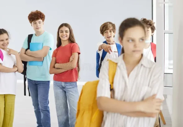 outcast-teenager-girl-suffering-bullying-school-group-classmates-laughing-behind-sad-female-standing-alone-her-331936089